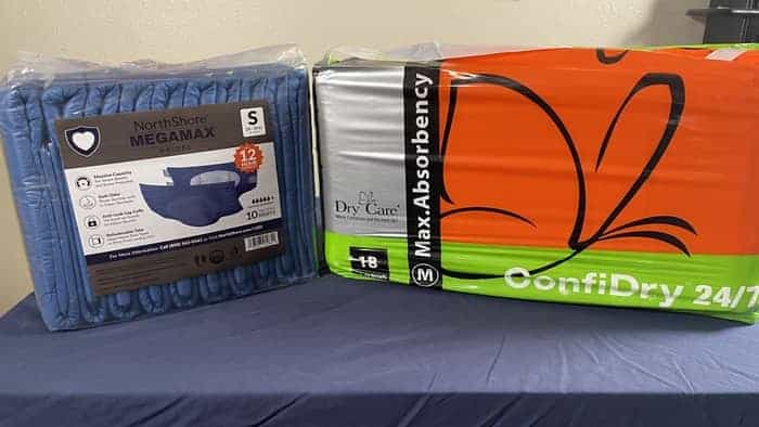 A display of two packages of adult diapers that would be great to wear for bedwetting. The Northshore Megamax and Confidry 24/7.