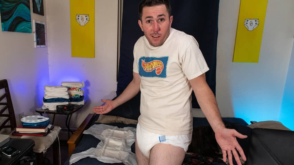 Confused man in a diaper trying to figure out if he should change.